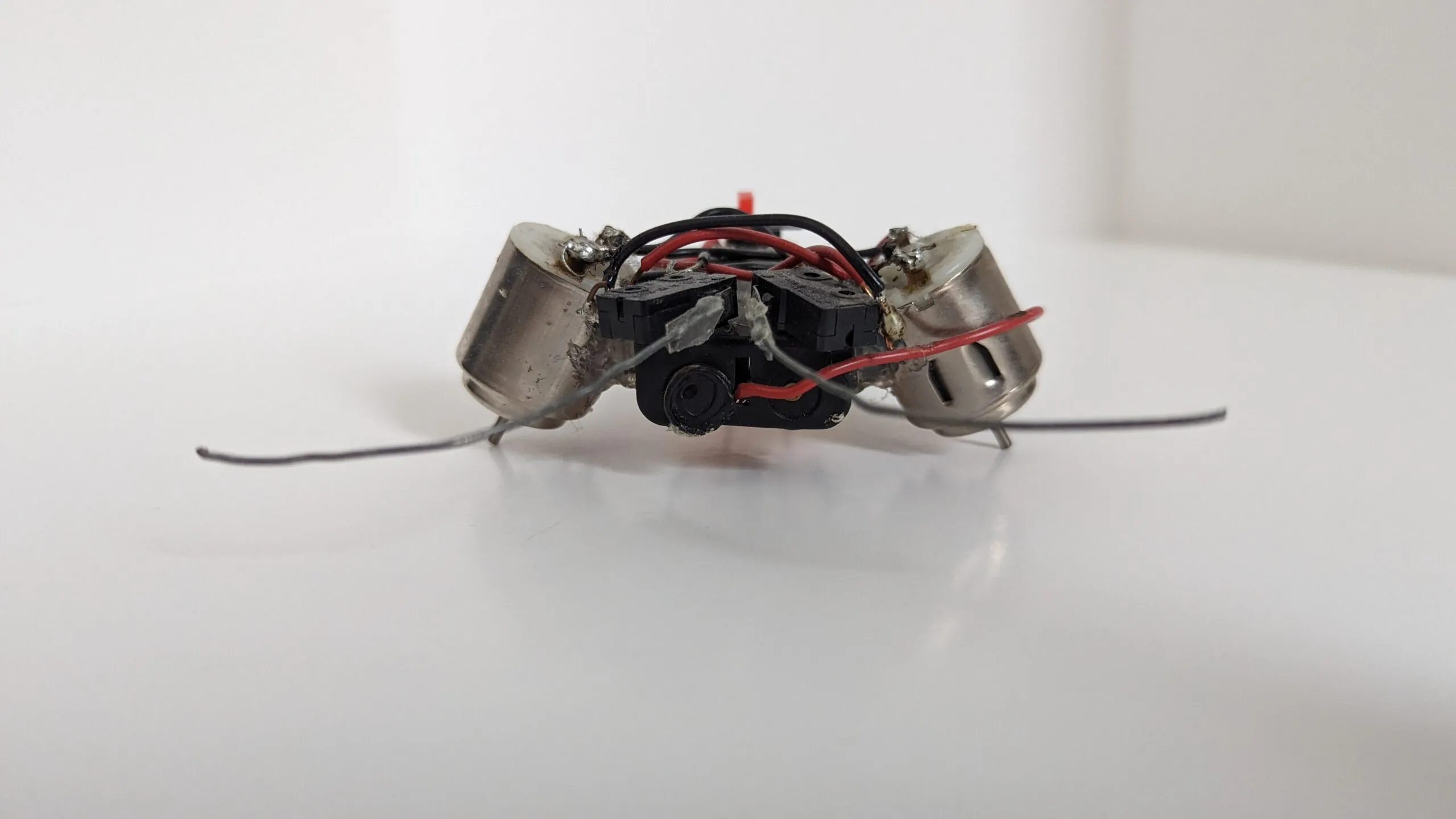 Head-on view of a Beetle with angled motor housings and a bump-switch block between them.