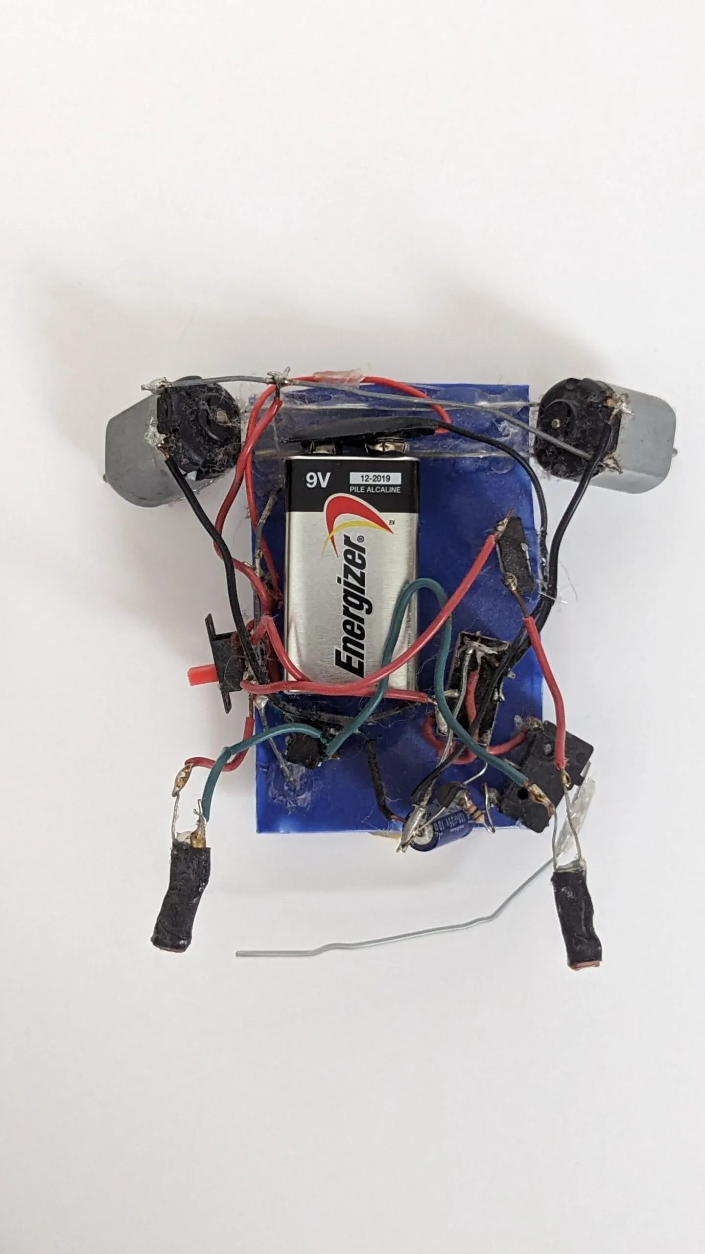 Top-down view of Herbie: the 9V dominates the blue chassis, motors at the far corners.