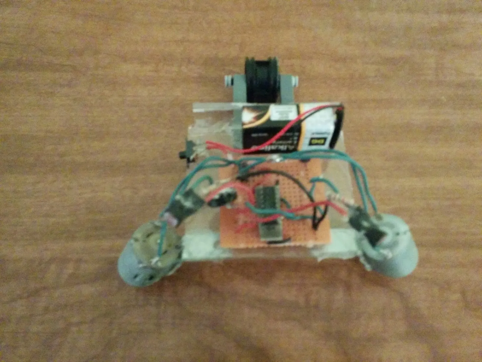 NoBB: protoboard brain and caster nose on a clear plastic chassis, twin motors at the back.