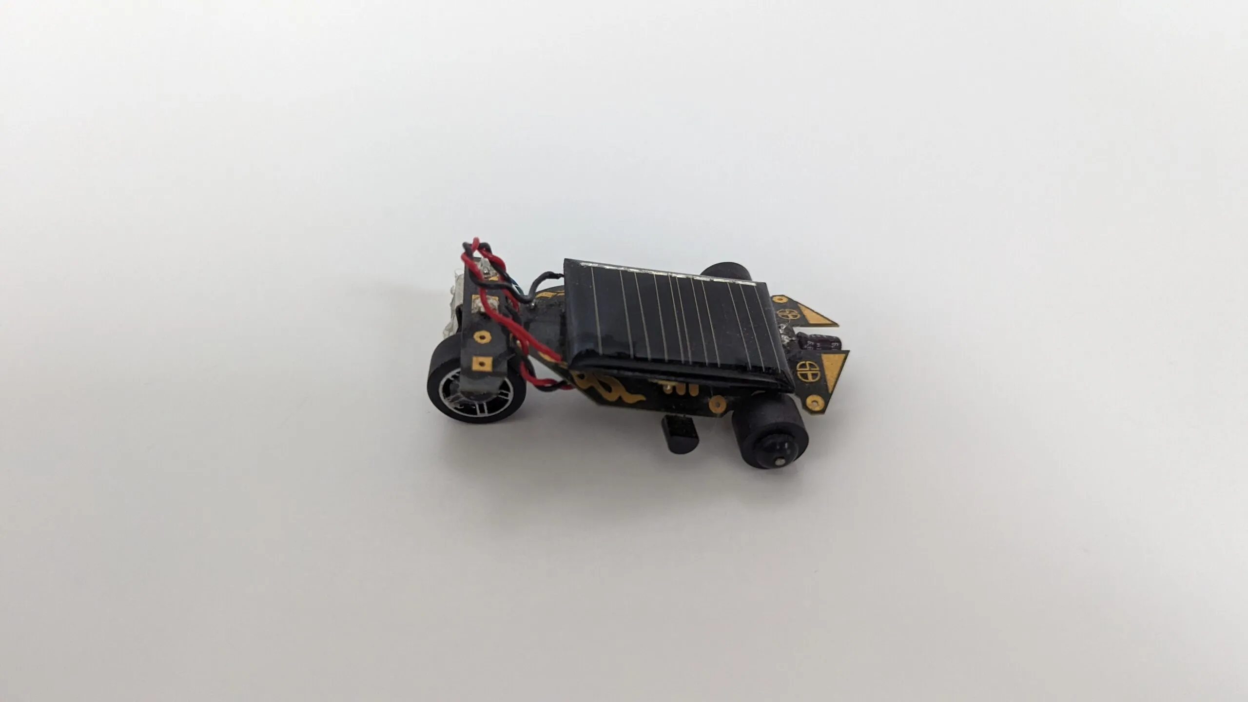 Side profile of the Solar Roller, spoked scavenged back wheel under the panel's edge.