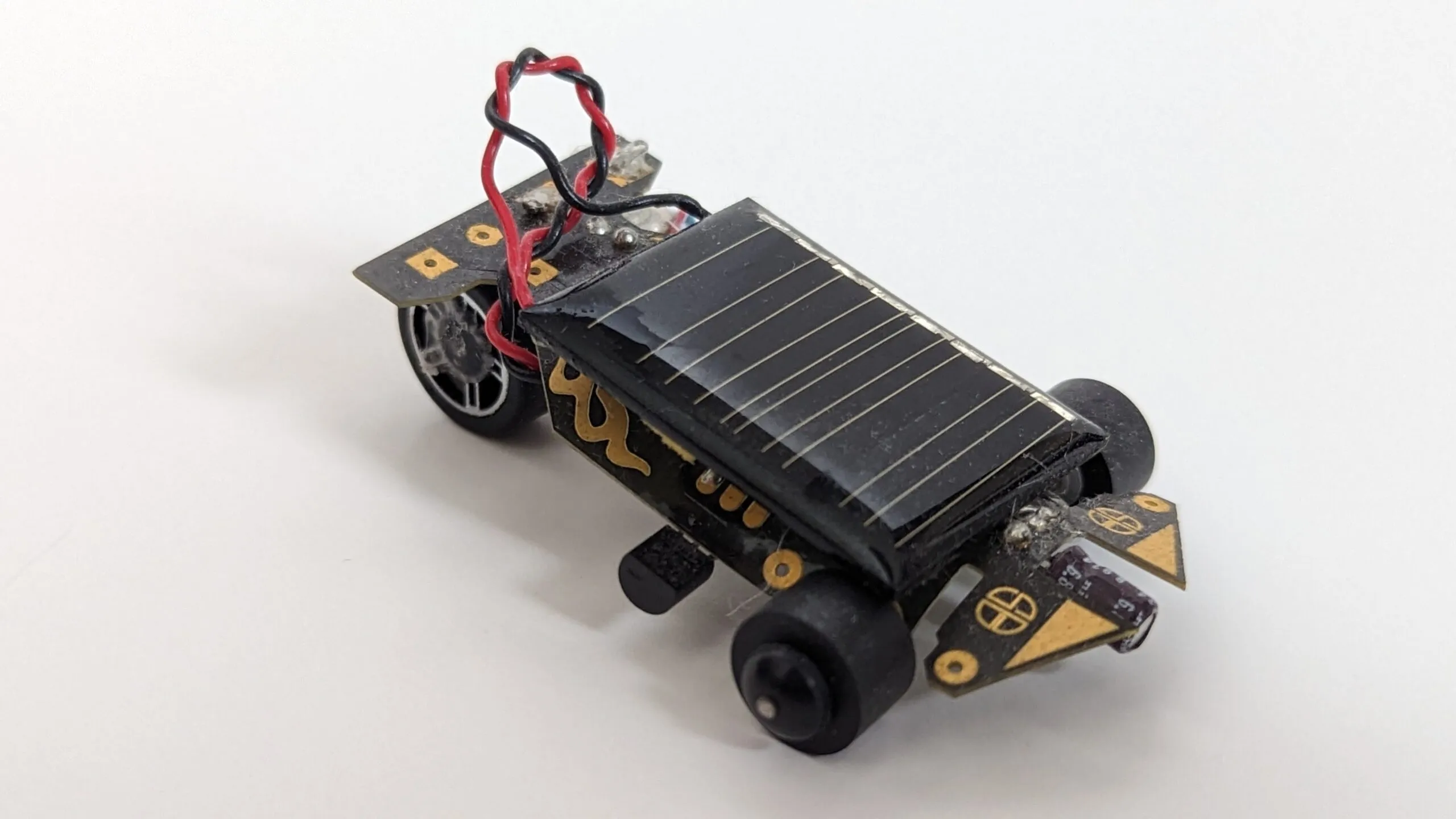 Three-quarter view of the Solar Roller showing its mismatched scavenged wheels.