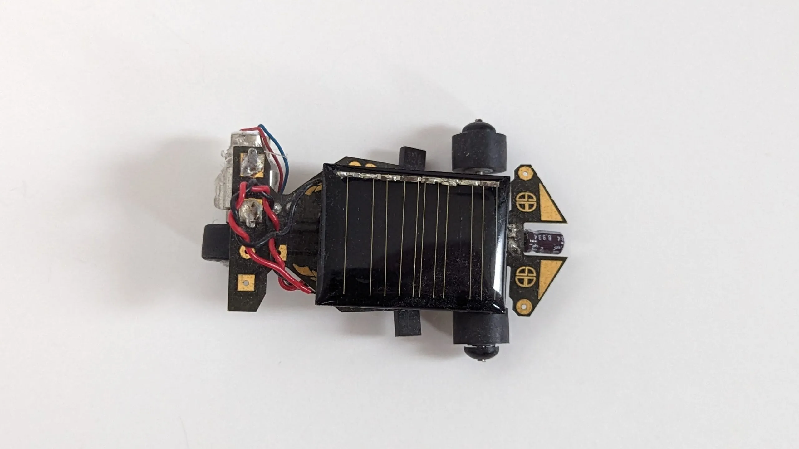 Top-down view of the Solar Roller: solar cell centered on the PCB chassis, drive motor at the tail.