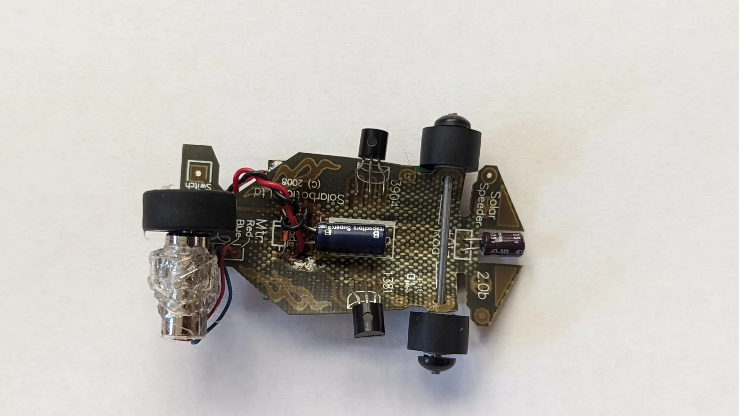 Underside of the Solar Roller: the Solarbotics Solar Speeder 2.0b board, supercap and driver transistors on show.