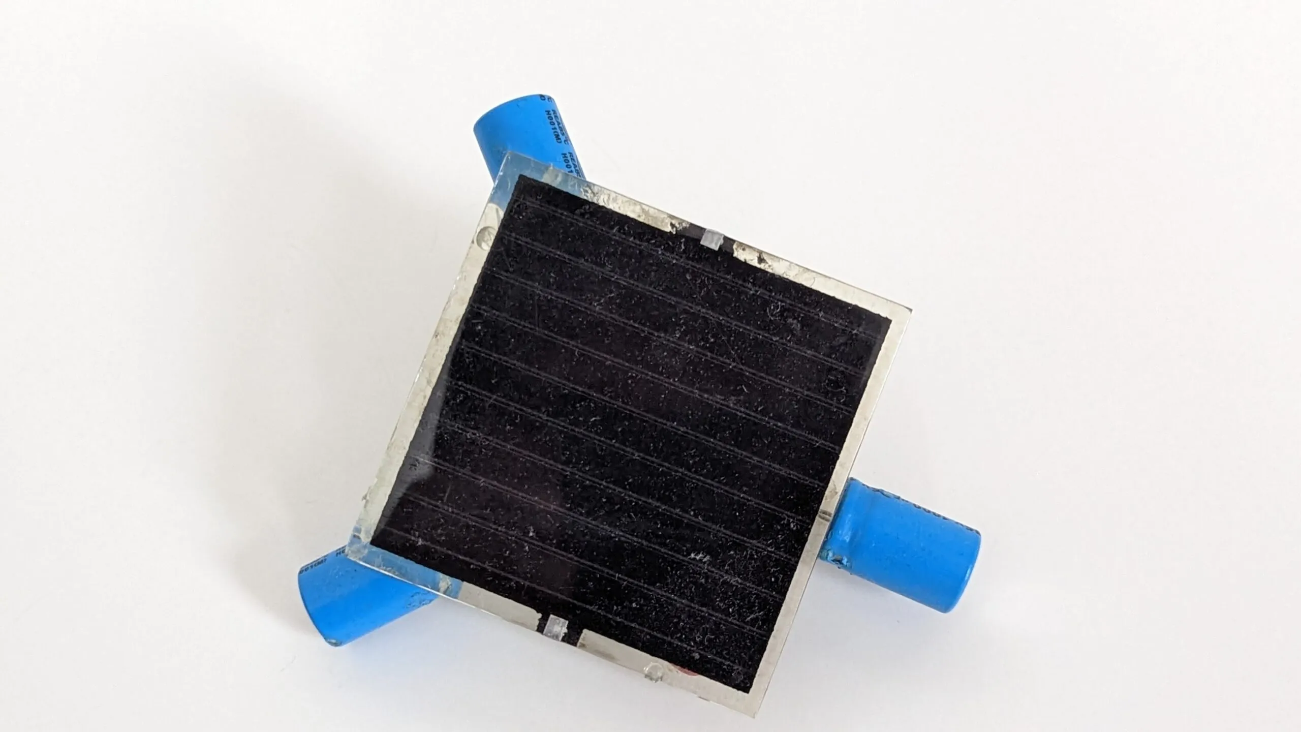 Close-up of the Symet's dusty solar cell, capacitor feet at the corners.