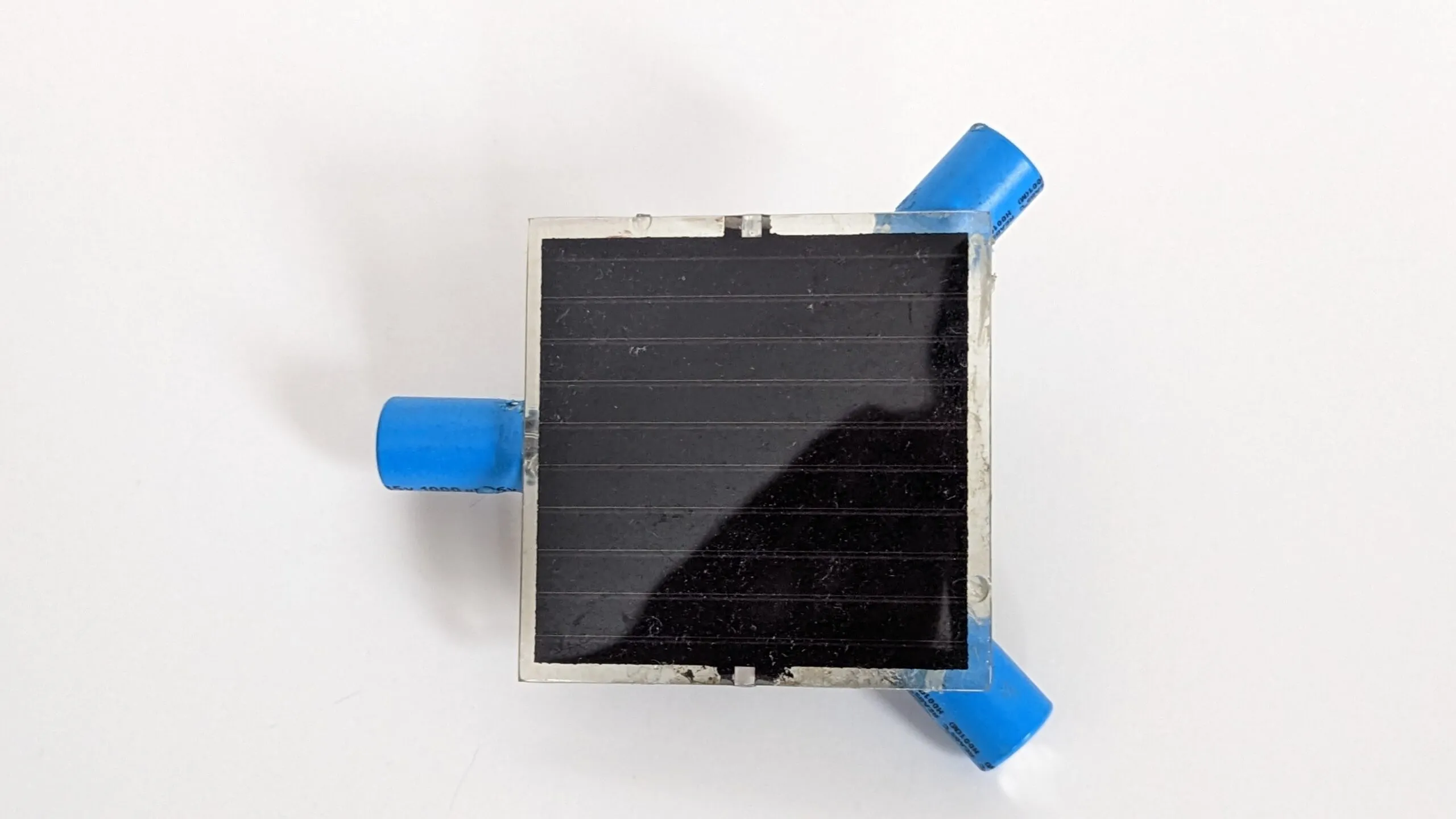 Top-down view of the Symet's solar cell with the three capacitor feet at its corners.