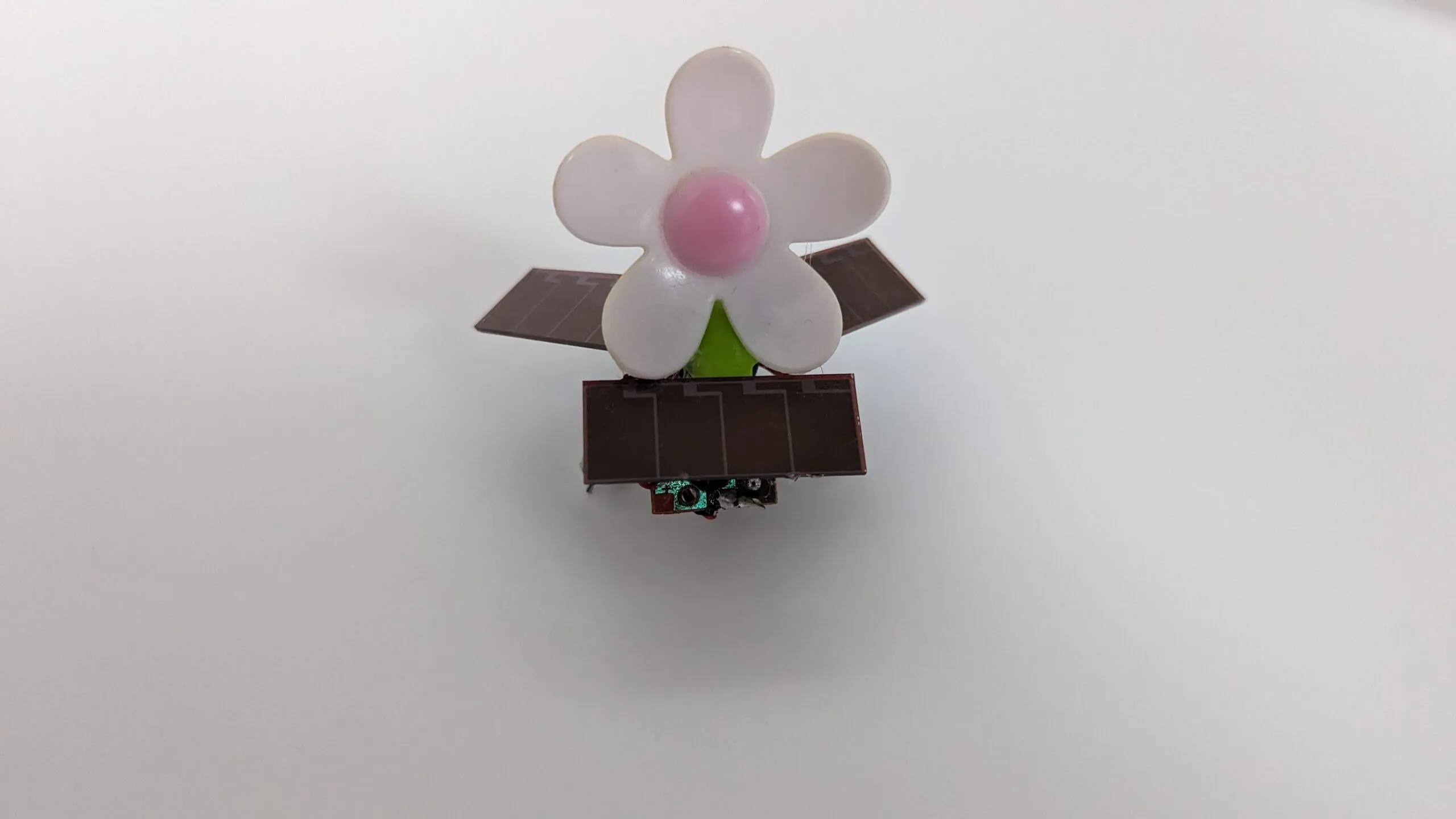 SymFlower v2 face on: daisy centered over the front solar panel, wings level.