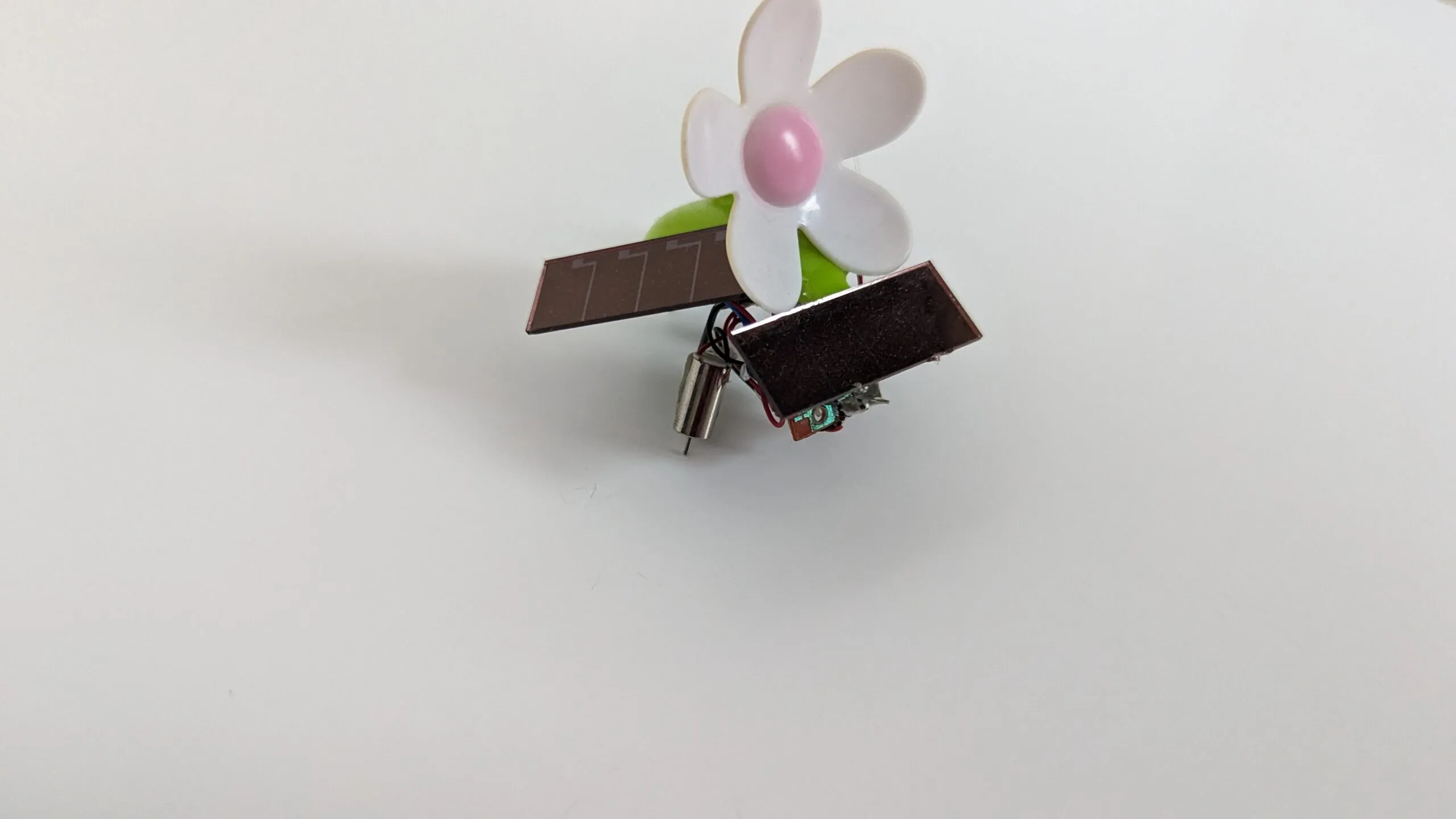 SymFlower v2 with its solar wings staggered fore and aft, a pager motor peeking underneath.