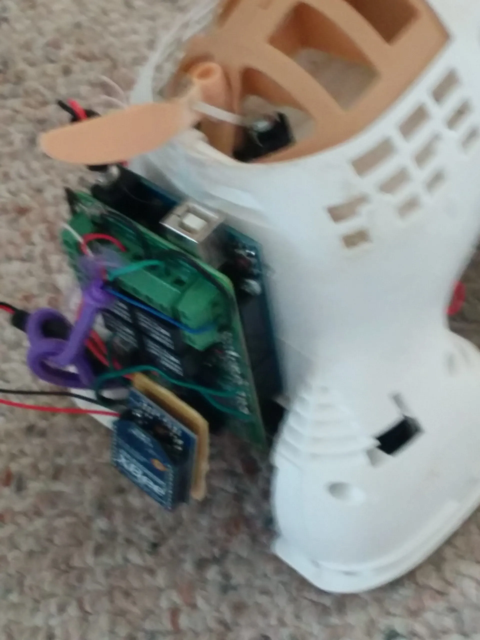The 2014 electronics package: Arduino with the relay shield's green terminal blocks and the XBee breakout dangling off it, hanging out of Bubbles' opened shell.