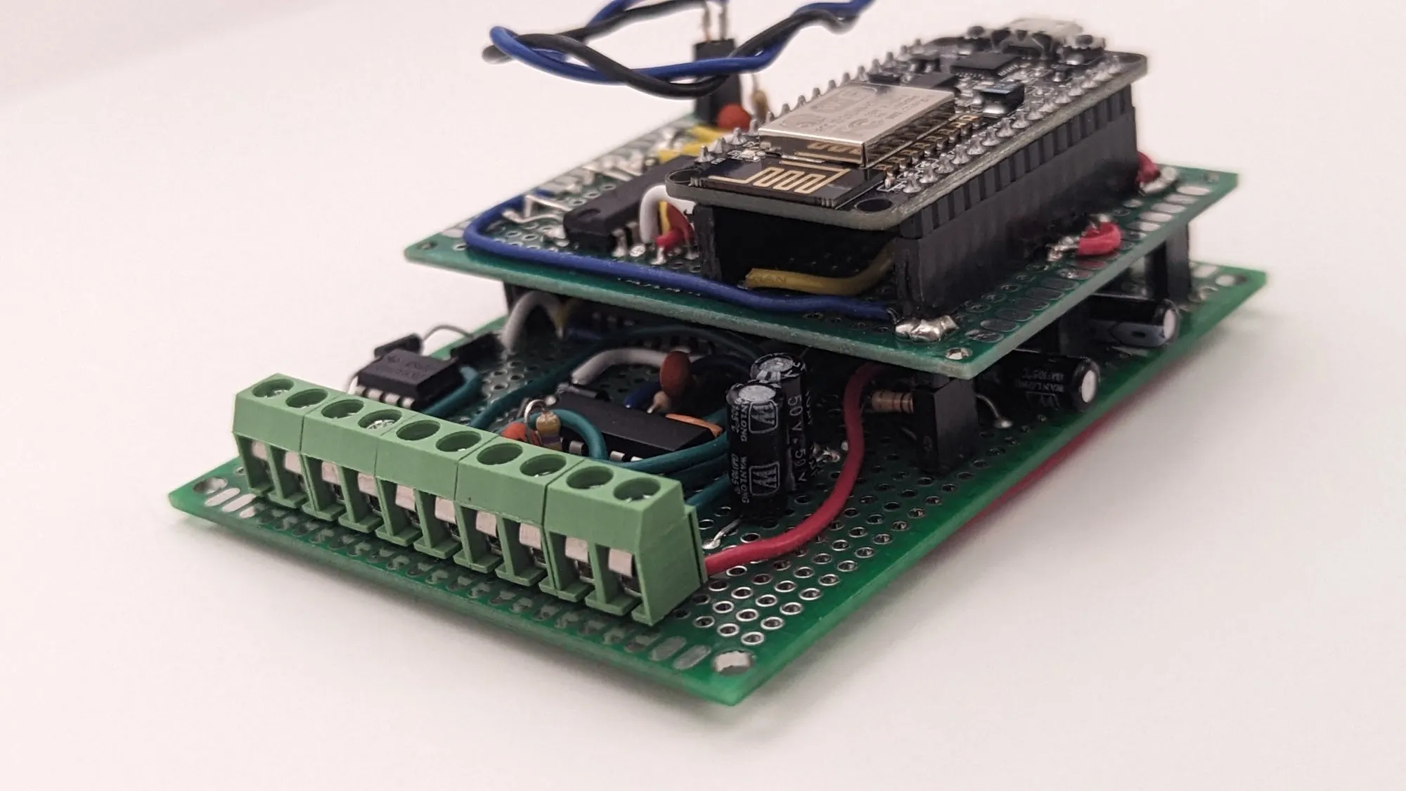 The stack from the terminal side, the row of green screw terminals below the NodeMCU board.