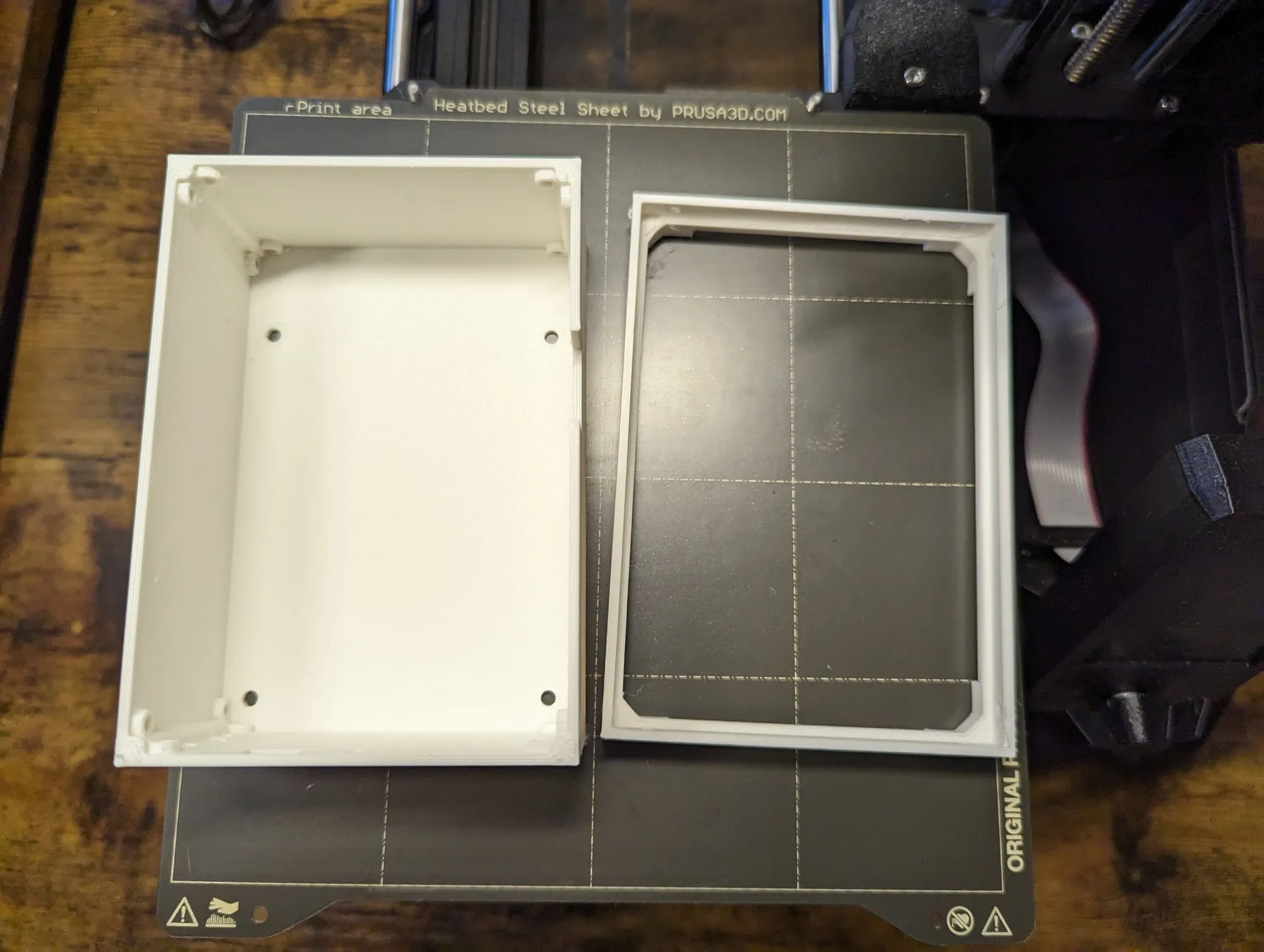 The white box and its lid side by side on the print bed.