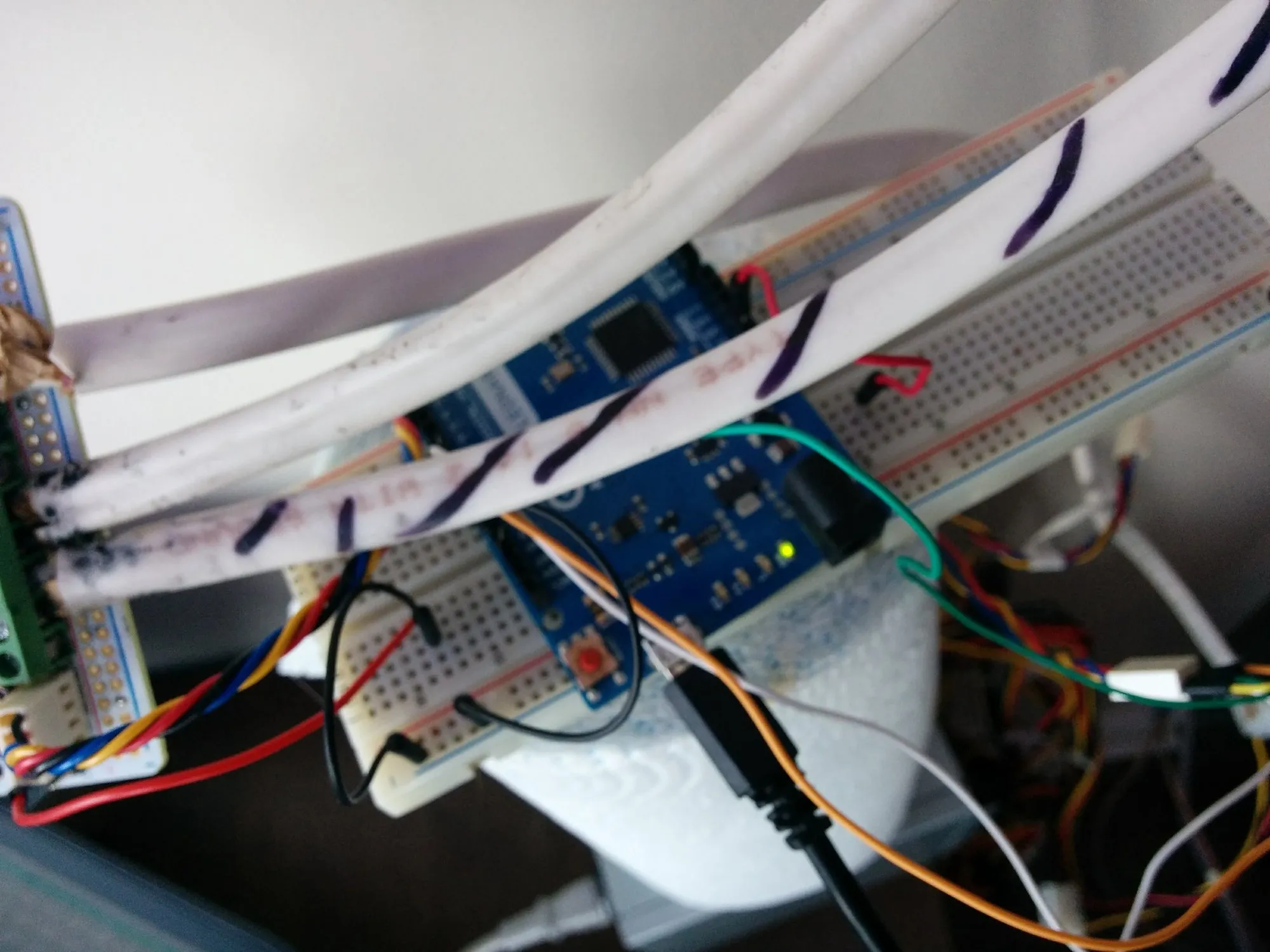 The test rig: an Arduino Leonardo on a breadboard propped on a paper-towel roll, the LED strips running overhead.