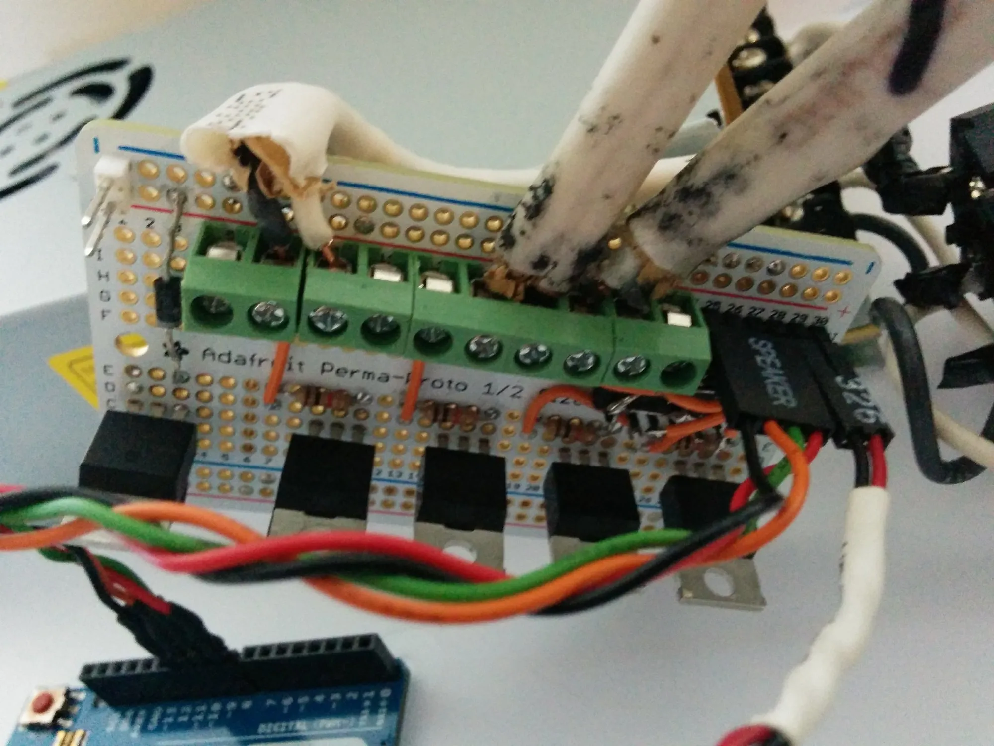 The finished switcher board in September: five transistors along the bottom, the green terminal block with the strips screwed in, an Arduino Leonardo in front.