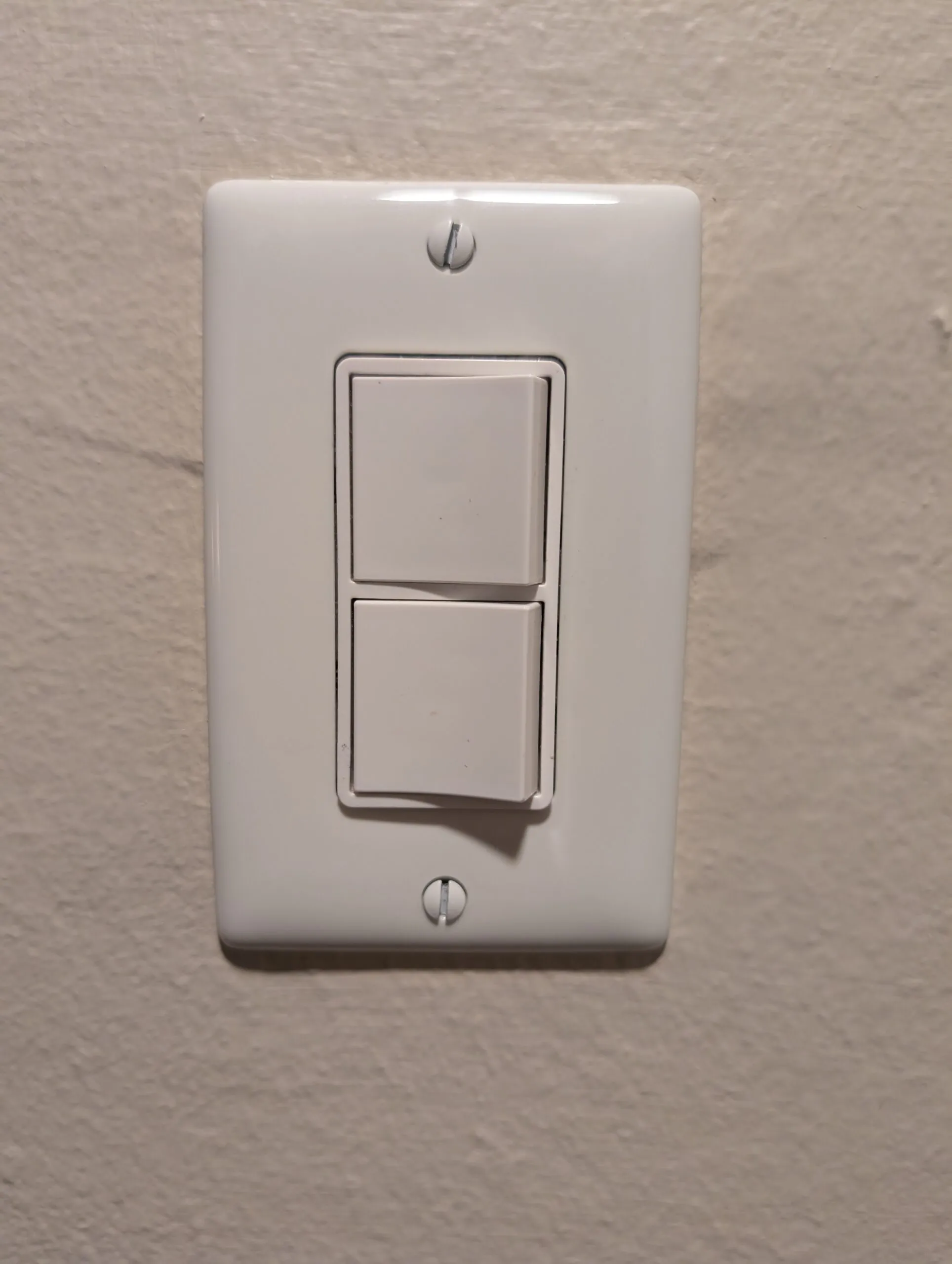 A stacked double rocker switch in a single wall plate.