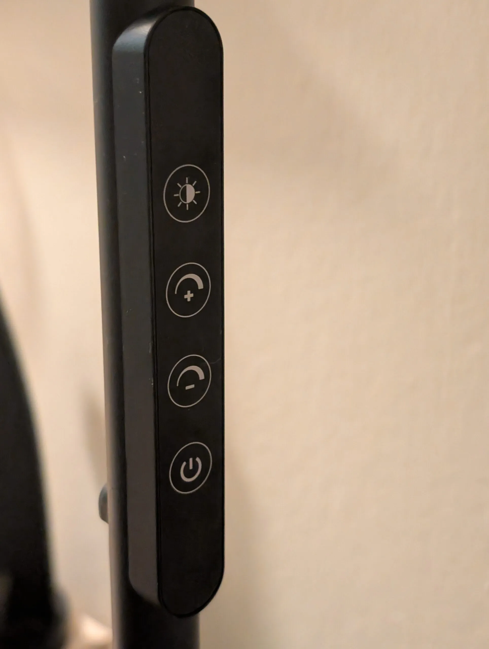 The lamp's touch strip on the pole: color temperature, brighter, dimmer, and power.