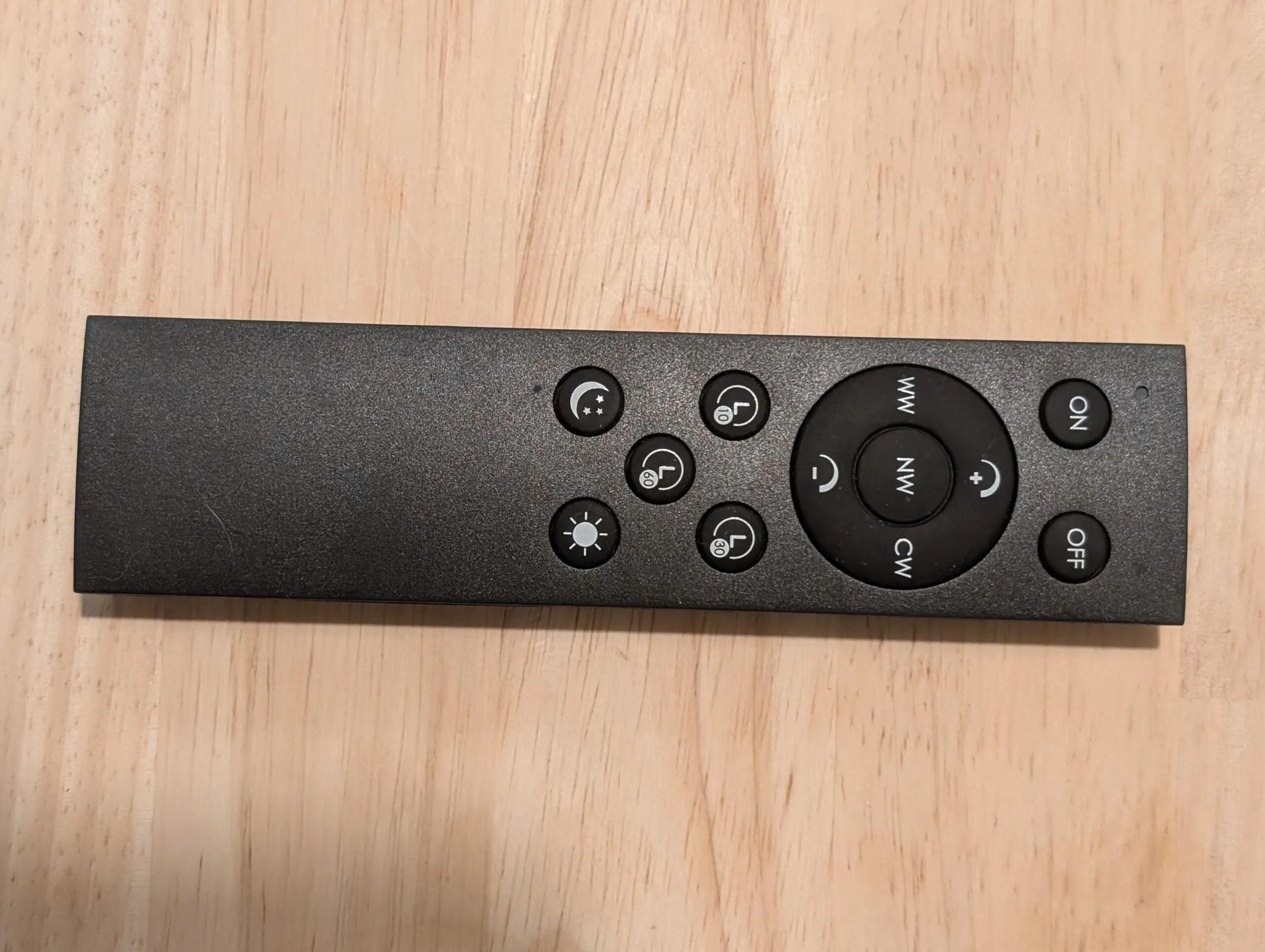 The lamp's remote: warm / neutral / cool white ring with dim and brighten, 10 / 30 / 60 minute timers, night mode, and ON and OFF.