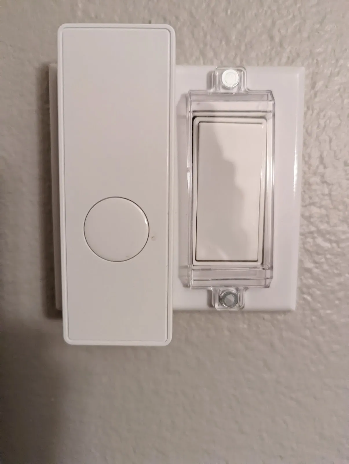 A Third Reality gen 2 smart switch mounted beside the covered rocker it presses.
