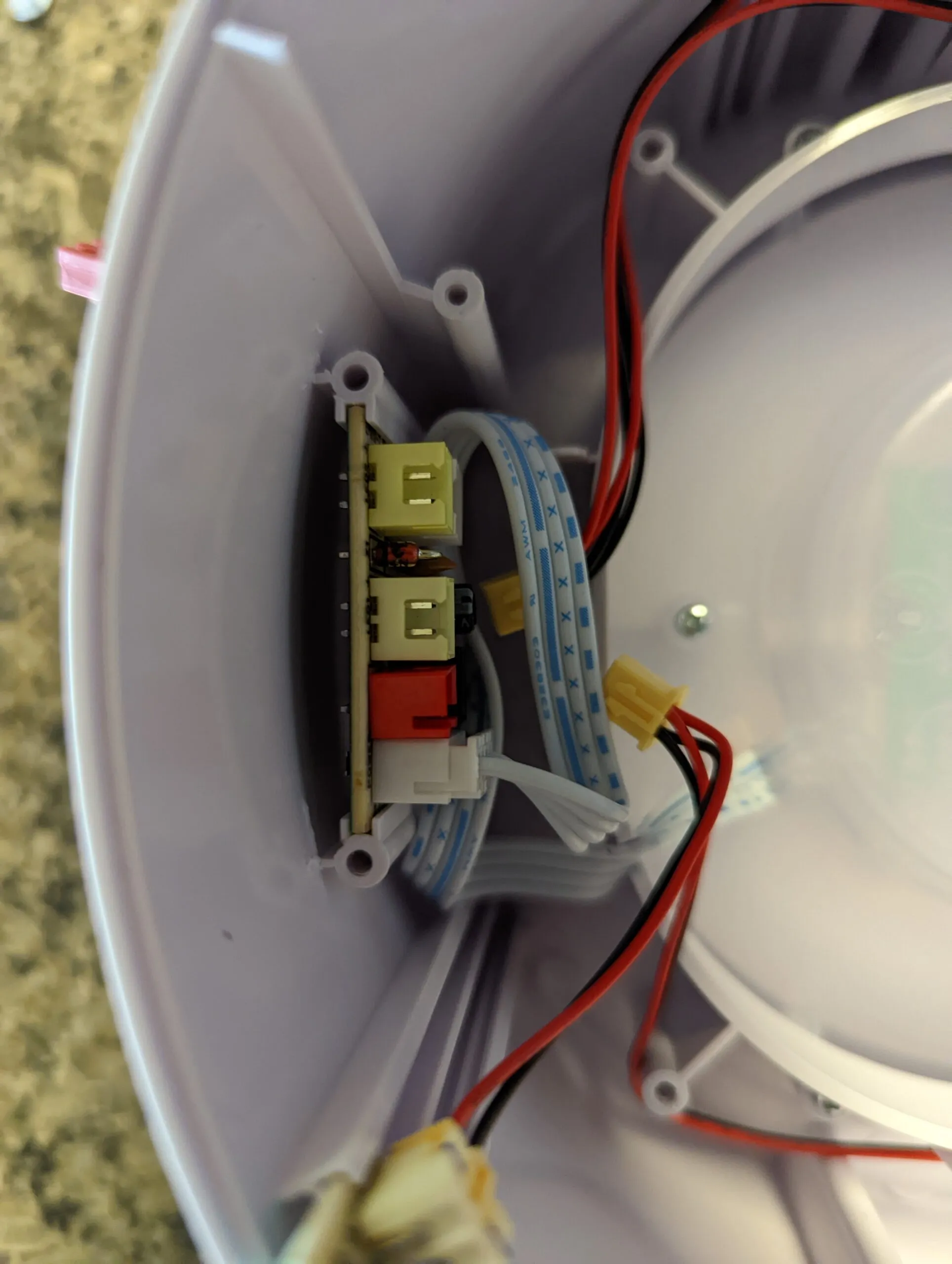 Same board with the fan out of the way: the LED ring plug pulled too, and the flat ribbon that runs up to the control dome.