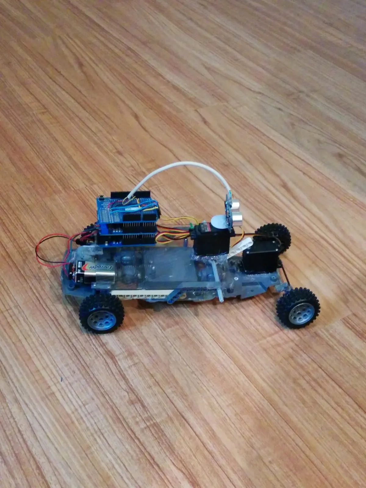 Side view of RoverBot in 2014: Arduino stack, 9V, and steering servo on the clear chassis.