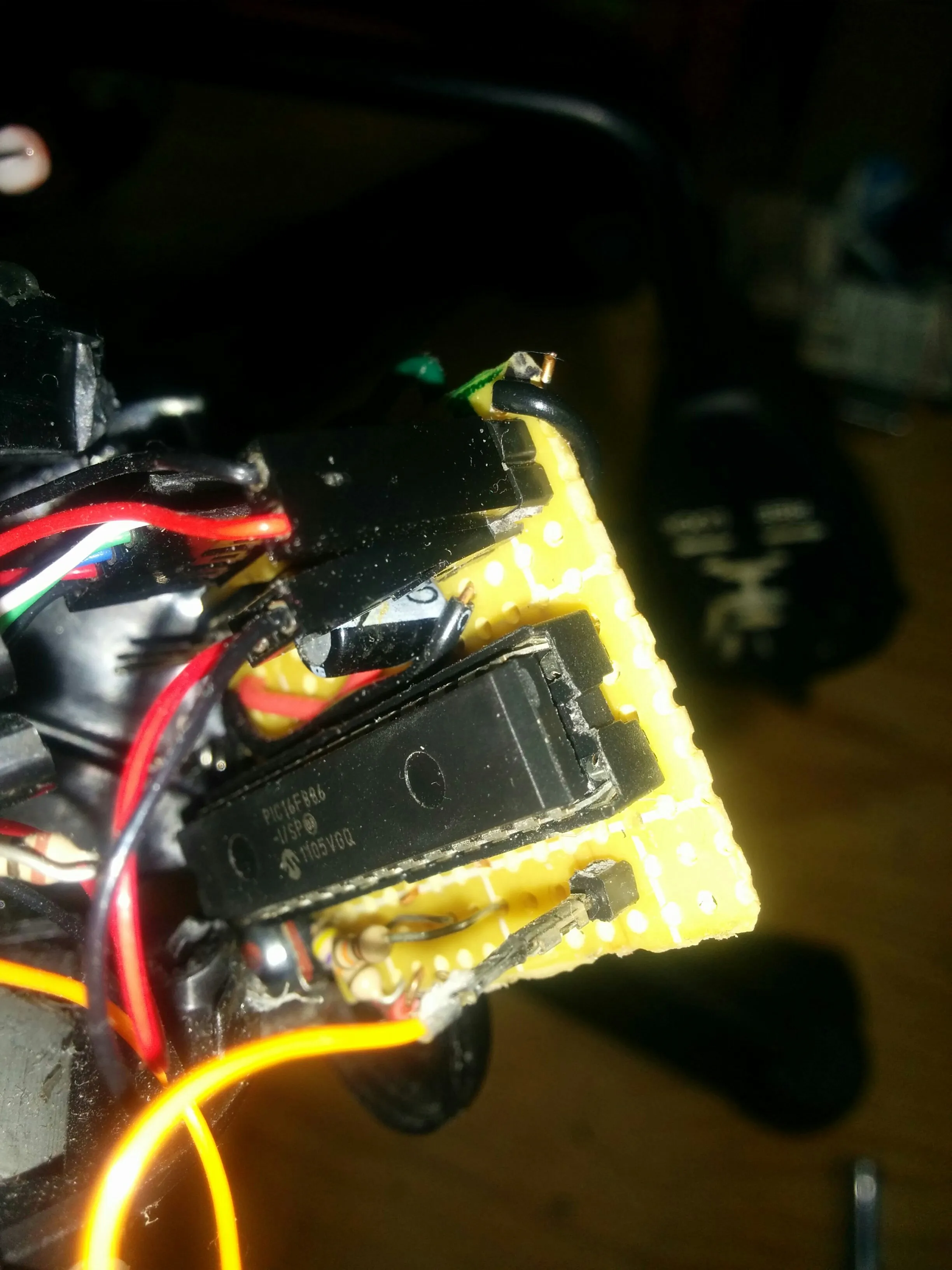 Close-up of the PIC16F886 and driver stacked on Triclops's perfboard.