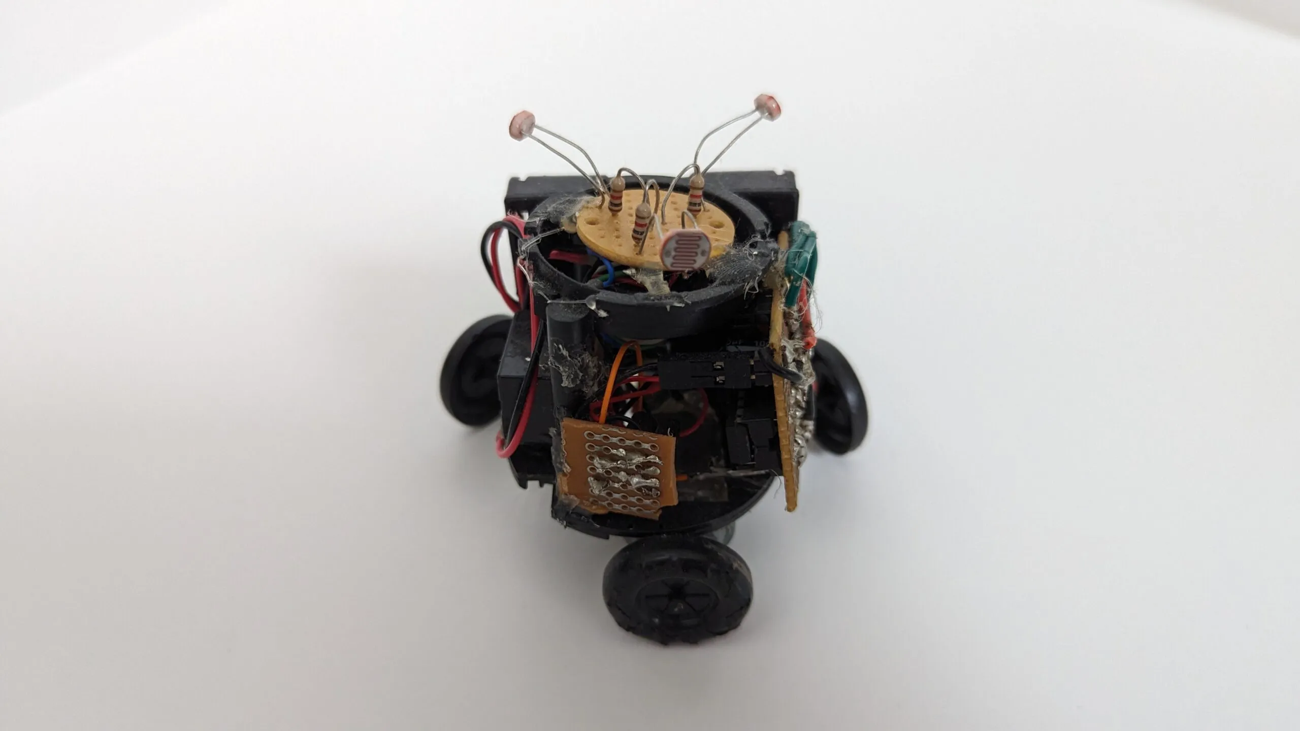 Triclops from above and ahead, photoresistor antennae spread wide on their stalks.