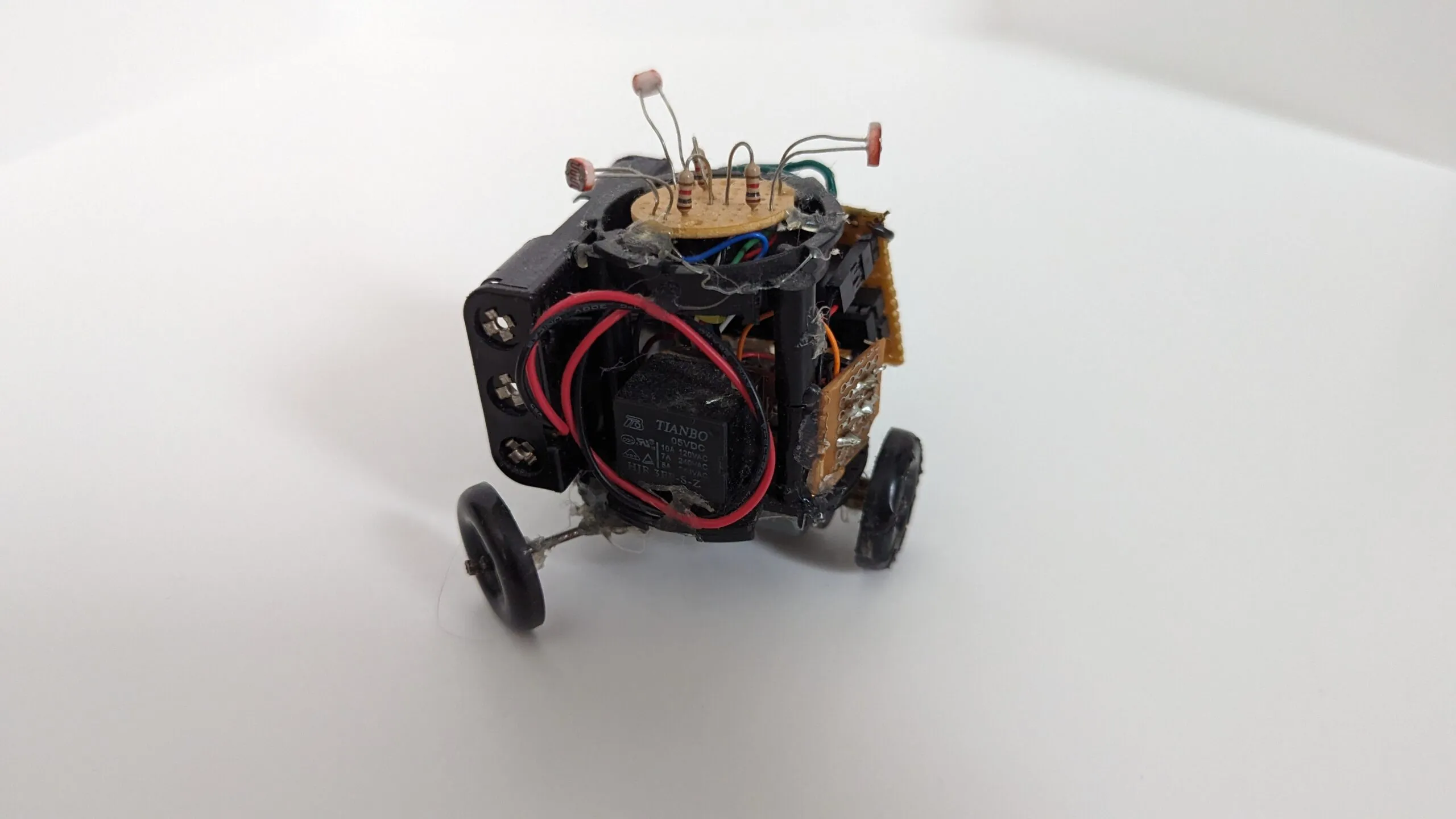 Triclops front-on, the 5 V relay riding its chest like armor.