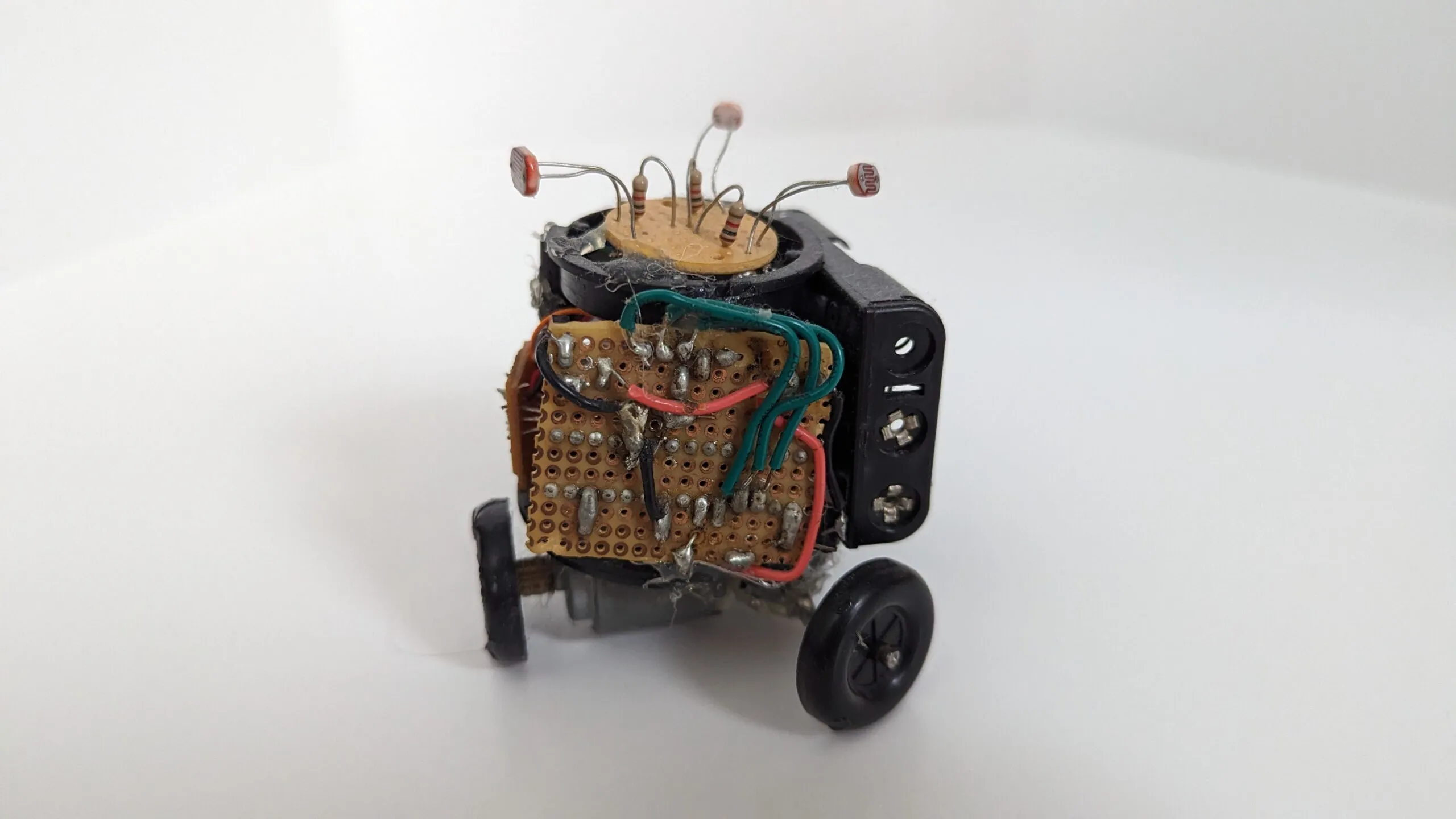 Studio side view of Triclops, the solder side of its perfboard facing out.