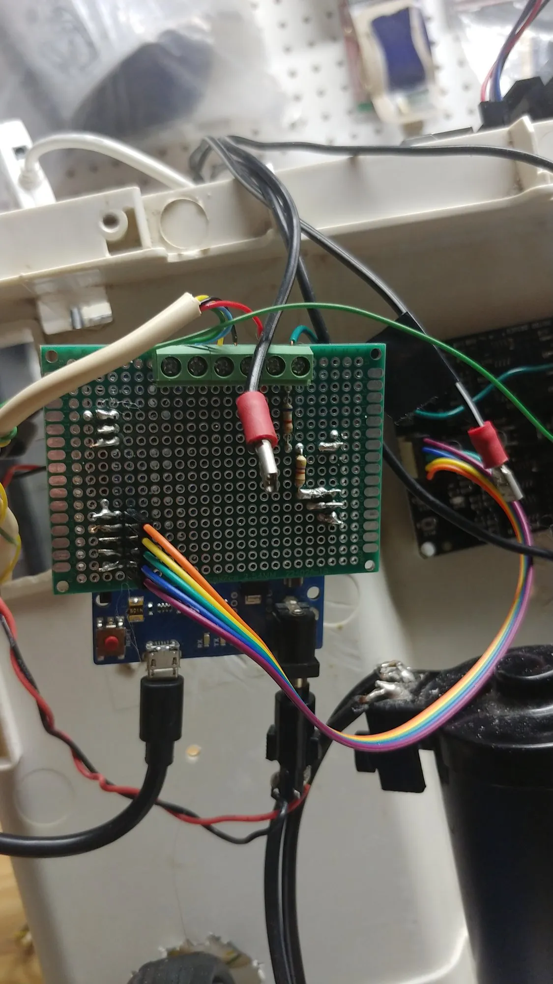 The Arduino Leonardo inside the shell with its perfboard interface board stacked on top, screw terminals along the top edge and a rainbow ribbon cable plugged in.